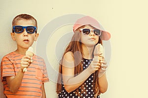 Kids boy and little girl eating ice cream.