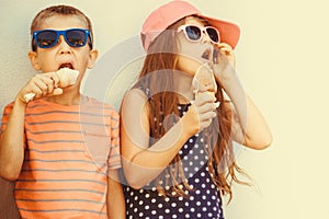Kids boy and little girl eating ice cream.