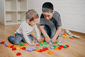 Kids boys are engaging in daycare. Two toddler children playing