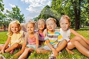 Kids, boys and girls on the lawn in park