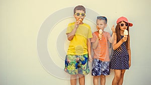 Kids boys and little girl eating ice cream.