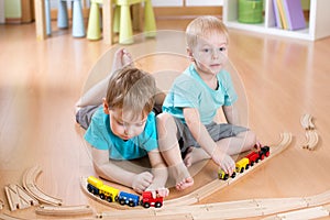Kids boys play with railroad and trains indoor, learning and daycare