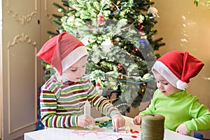 Kids brothers child boys making by hands x-mas decorations