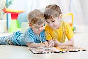 Kids brothers read a book at home photo