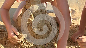 Kids building a sand structure.