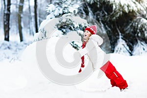 Kids building snowman. Children in snow. Winter fun.