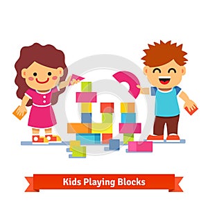 Kids building tower with colorful wooden blocks