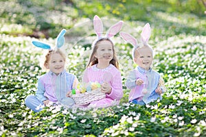 Kids with bunny ears on Easter egg hunt.