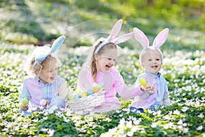 Kids with bunny ears on Easter egg hunt.