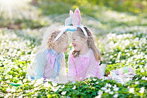 Kids with bunny ears on Easter egg hunt.