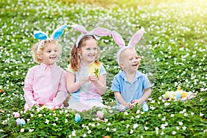 Kids with bunny ears on Easter egg hunt.