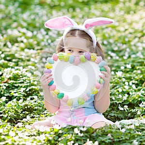 Kids with bunny ears on Easter egg hunt.