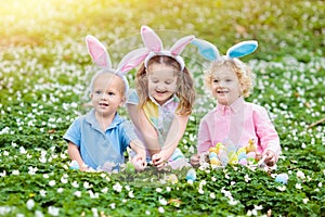 Kids with bunny ears on Easter egg hunt.