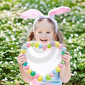 Kids with bunny ears on Easter egg hunt.