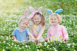 Kids with bunny ears on Easter egg hunt.