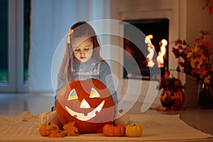 Kids carving pumpkin on Halloween. Trick or treat.