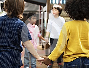 Kids in casual holding hands in a circle