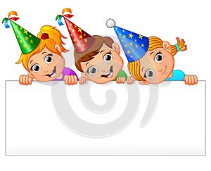 Kids celebrating birthday party with holding blank sign