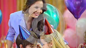 Kids celebrating their birthday with mother and fiends at restaurant.