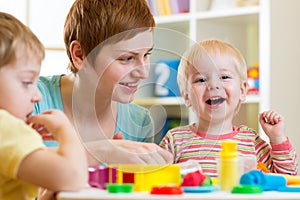 Kids or children and mother play colorful clay toy