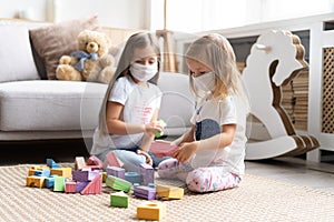 Kids children wearing mask for protect Covid-19, playing block toys in playroom.