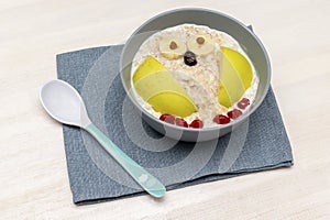 kids childrens babys breakfast lunch oatmeal porridge in bowl look like owl decoration with apple, banana, dried berry