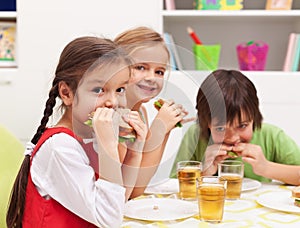 Kids chomping on sandwiches