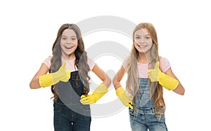 Kids cleaning together. Girls with yellow rubber protective gloves ready for cleaning. Household duties. Little helper