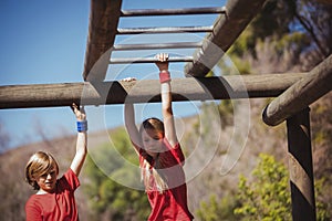 Kids climbing monkey bars during obstacle course training