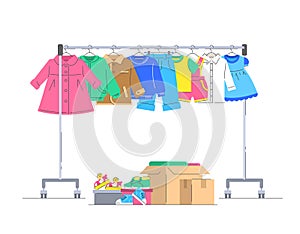 Kids clothes and shoes on hanger rack for donation