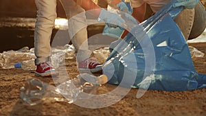 kids collecting trash teamwork volunteer a child group. happy family on collects garbage plastic trash waste bottles