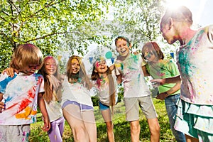 Kids colored with color powder dancing outdoor