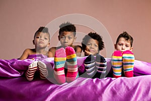 Kids in colorful socks sitting.