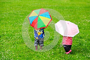 Kids with colorful umbrellas on rainy day