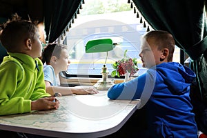 Kids in compartment of retro train carriage