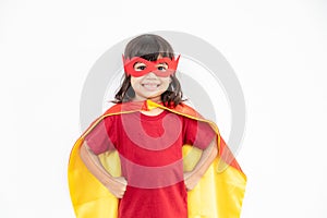 Kids concept, smiling girl playing super hero on white background