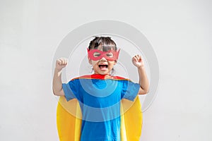 Kids concept, smiling girl playing super hero on white background