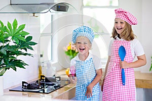 Kids cook in white kitchen. Children cooking