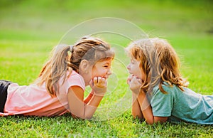 Kids couple in love. Two children on spring field. Adorable happy child outdoors on sunny day.