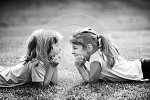 Kids couple in love. Two children on spring field. Adorable happy child outdoors on sunny day.