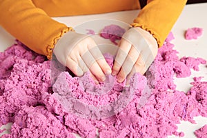 Kids creativity. Kinetic sand games for child development at home. Sand therapy. Children`s hands making moldes photo