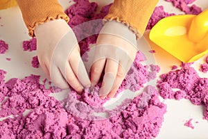 Kids creativity. Kinetic sand games for child development at home. Sand therapy. Children`s hands making starfish photo