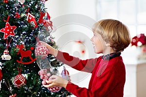 Kids decorate Christmas tree. Child on Xmas eve