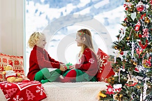 Kids decorate Christmas tree. Child on Xmas eve