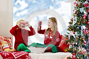 Kids decorate Christmas tree. Child on Xmas eve photo