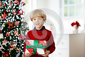 Kids decorate Christmas tree. Child on Xmas eve