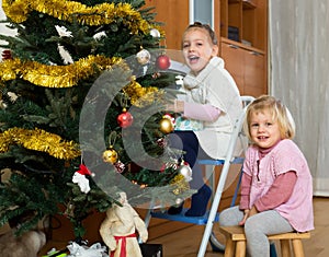 Kids decorate fir for Christmas