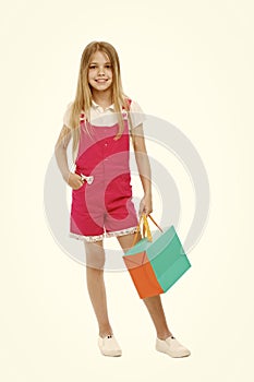 Kids designer clothing summer sale. Girl cute teenager carries shopping bag. Kid bought clothing summer sale. Sale