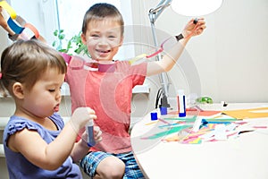 Kids development - children making paper garland