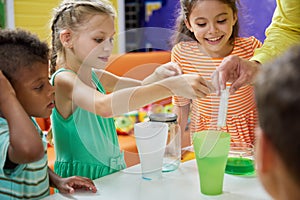 Kids doing chemical experiment at entertainment center.